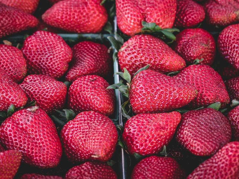 A high fidelity close-up of a chef's hands precisely garnishing a complex plated dish with micro-herbs, dark background, cinematic smoke, no woman